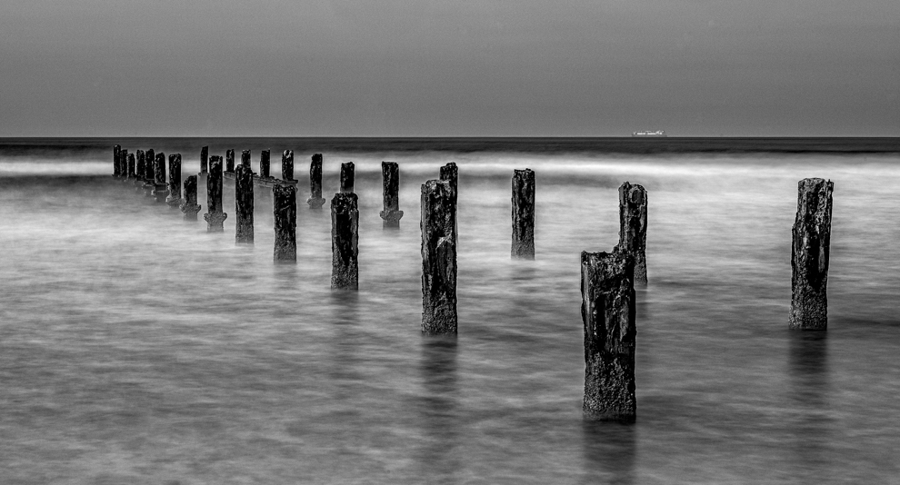 Pilings in the sea by dannypo